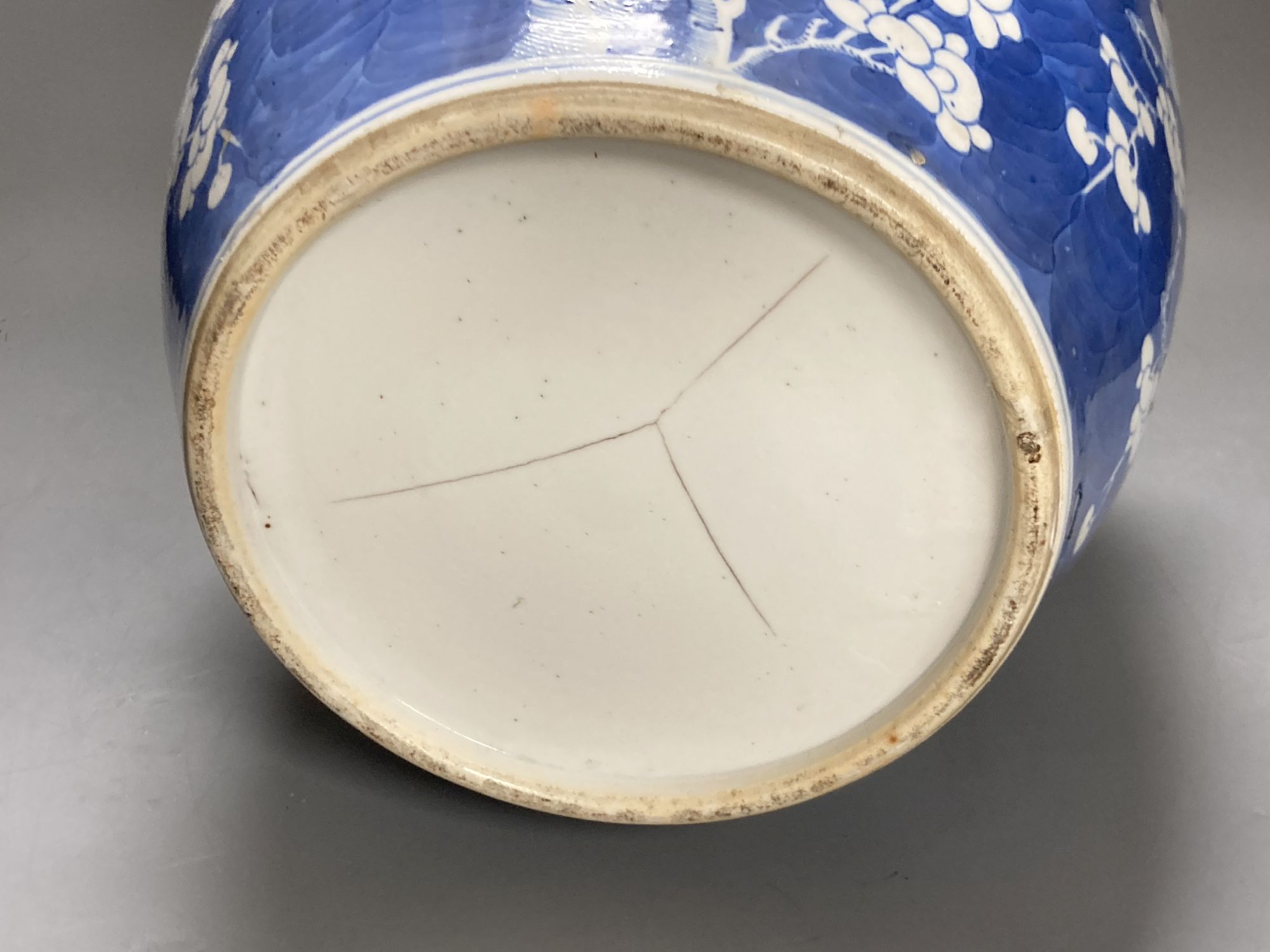 A large 19th century Chinese blue and white prunus jar and cover, height 35cm, and a late 20th century Chinese blue and white stick sta